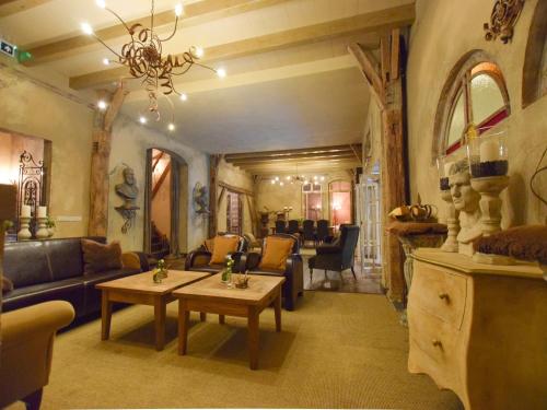 a living room with a couch and a table at Holiday Home in Alphen near Het Zand Beach in Alphen