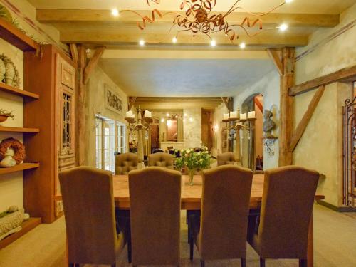 a dining room with a large wooden table and chairs at Holiday Home in Alphen near Het Zand Beach in Alphen