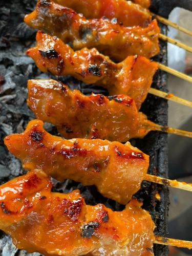 a group of food cooking on a grill at Green Merta in Padangbai