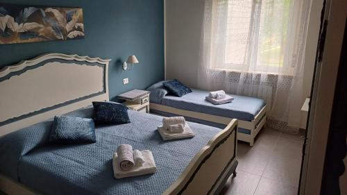 a bedroom with two beds with towels on them at La Casa nel Parco in Moncalieri