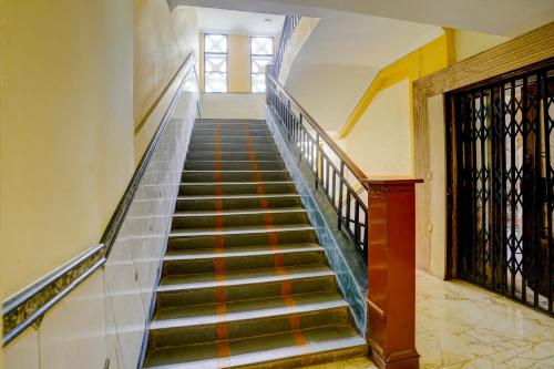 a stairway in a building with a staircase at Hotel O Royal Inn in Mumbai