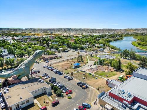 an aerial view of a city with a dinosaur statue at The Red Steps Away From World's Largest Dinosaur 3BR House in Drumheller