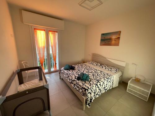 a bedroom with a bed and a window at Villa Primule Cattolica in Cattolica