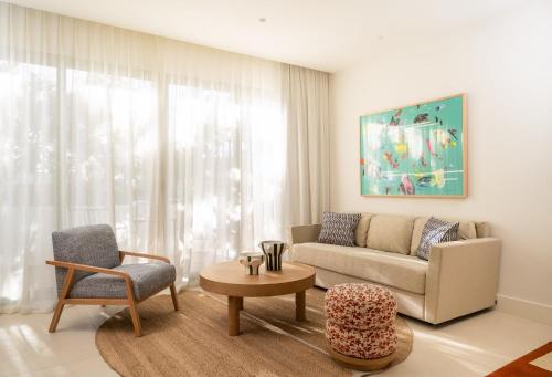 a living room with a couch and a chair at Kimpton Los Monteros Marbella by IHG in Marbella