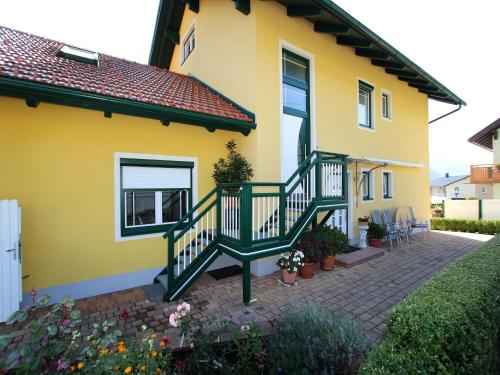 a yellow house with a staircase in front of it at Apartment in Katschberg near Ski Slopes in Rennweg