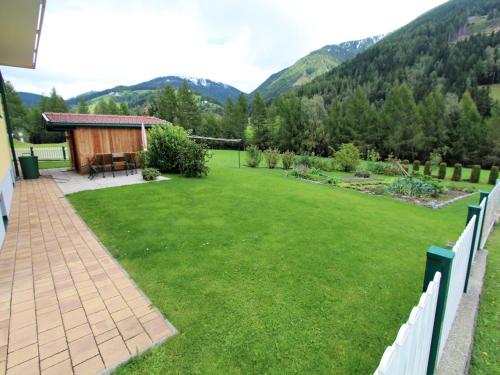 a backyard with a lawn and a fence at Apartment in Katschberg near Ski Slopes in Rennweg