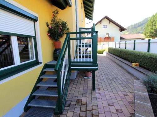 a green stairway next to a yellow building at Apartment in Katschberg near Ski Slopes in Rennweg