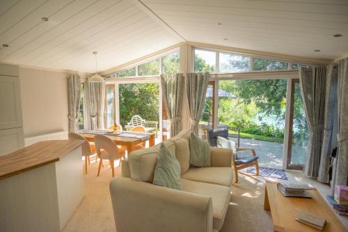 a living room with a couch and a table at Welhams Meadow Holiday Lodges in Ringshall
