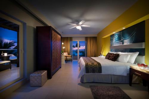 a hotel room with a bed and a living room at Hard Rock Hotel Vallarta All Inclusive in Nuevo Vallarta 