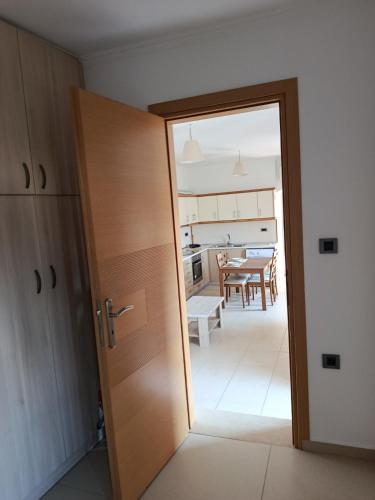 an open door to a kitchen with a table at Doukissa's Apartment in Symi