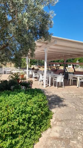 a group of tables and chairs under a pavilion at Dimora del Sole in Putignano
