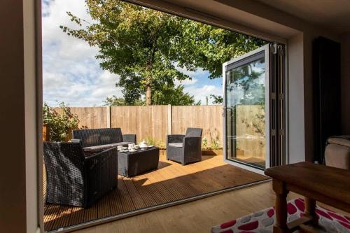 a living room with a large sliding glass door at Abbey Rectory - with private parking in Bath