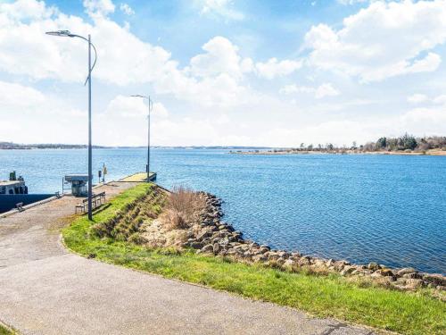 a bench next to a large body of water at 14 person holiday home in Højslev in Sundstrup