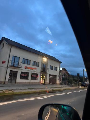 a building on the side of a street with a car at Zen in Talmesch