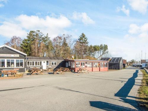 a street with a building with a picnic table at 14 person holiday home in Højslev in Sundstrup
