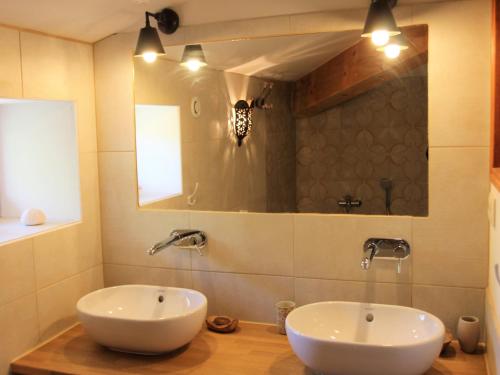 a bathroom with two sinks and a mirror at Private Pool in Provence in La Motte