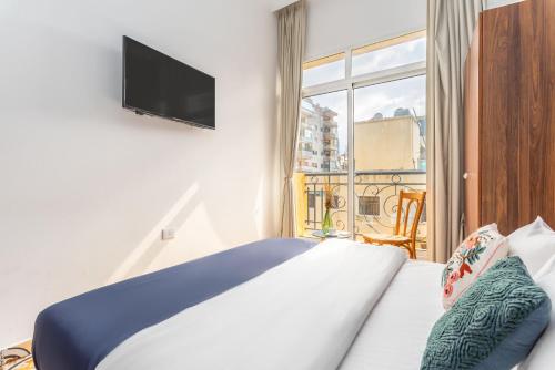 a hotel room with a bed and a window at Mar Mikhael Studios in Beirut
