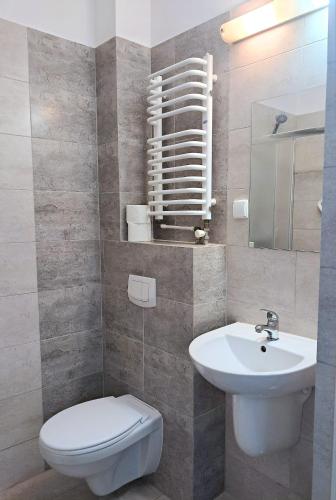 a bathroom with a white toilet and a sink at Hotel Sezam Kraczkowa Smart Lock in Kraczkowa