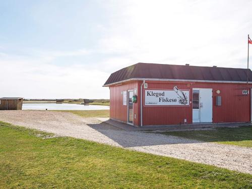 a red building with a sign on the side of it at 18 person holiday home in Ringkøbing in Ringkøbing