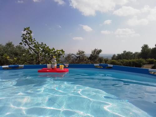 a swimming pool with a table in the water at Poderino La Noce in Vinci