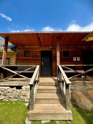 a wooden ramp leading to a house with a door at Arashan Hotel in Mineralʼnyy Istochnik Altyn-Arasan