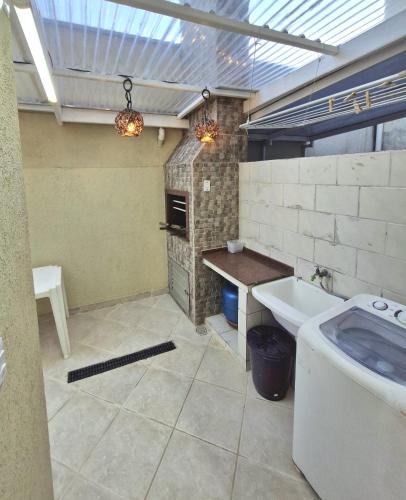 a large bathroom with a sink and a stove at Sobrado charmoso 2 in Guaratuba
