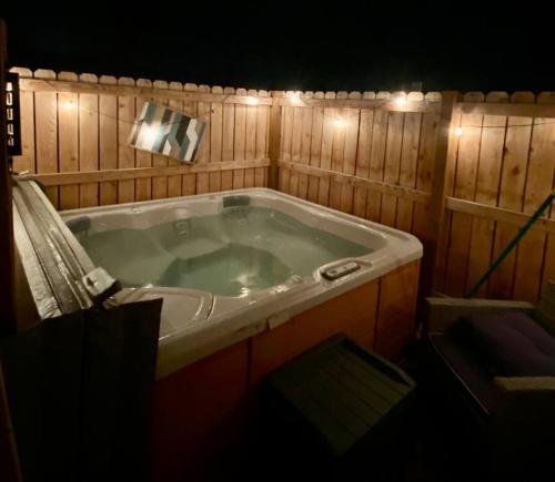 a large bath tub in a room with lights at Dog Friendly Oasis Private Hot Tub with Sauna in Boulder