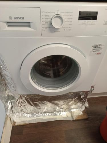 a washing machine with tin foil on top of it at Your Home Away From Home 4 Mins From Barking Station in Barking