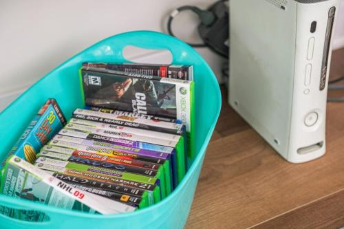 a basket full of books next to a nintendo wii game system at Pocono Escape Style and Serenity in Pocono Pines
