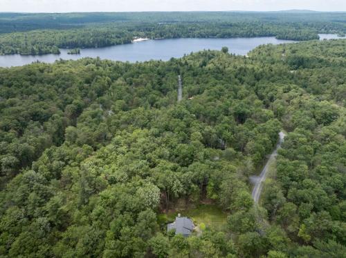 an aerial view of a house in the middle of a forest at Pocono Escape Style and Serenity in Pocono Pines