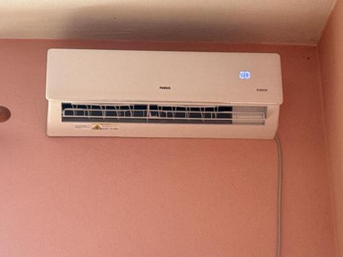 a air conditioner on a wall in a room at Hill Haven Guesthouse in Domje