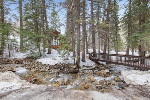 a stream in the woods with snow and trees at Hildas Haven on the Stream Sundance Utah in Sundance