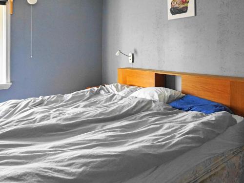 an unmade bed in the corner of a bedroom at 8 person holiday home in Henån-By Traum in Henån