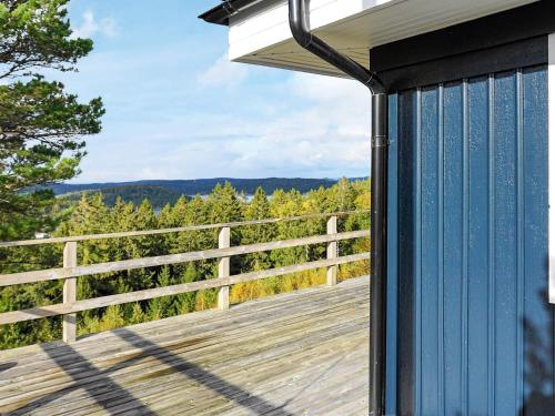 a deck with a view of the woods at 8 person holiday home in Henån-By Traum in Henån