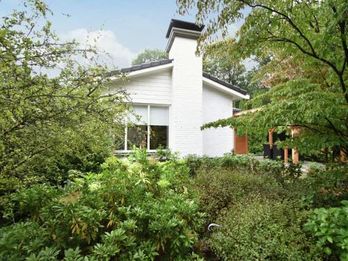 a white house with trees in front of it at Holiday Home in Holten near Holterberg in Holten