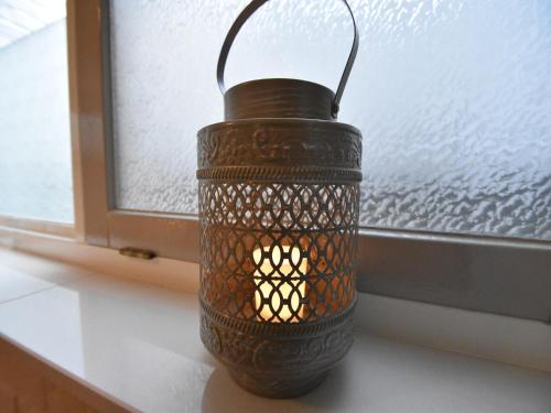 a black lantern sitting on a window sill at Holiday Home in Holten near Holterberg in Holten