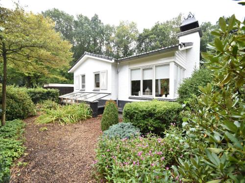 a white house with a garden in front of it at Holiday Home in Holten near Holterberg in Holten