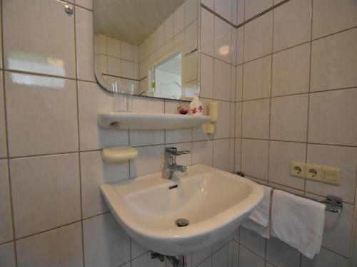 a white bathroom with a sink and a mirror at Holiday Home in Holten near Holterberg in Holten