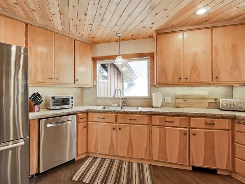 a kitchen with wooden cabinets and a stainless steel refrigerator at Mountain Haven Sundance Utah in Sundance