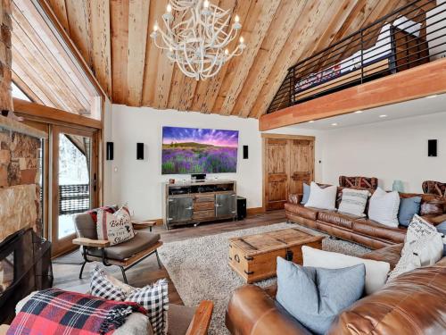 a living room with a couch and a tv at Mountain Haven Sundance Utah in Sundance