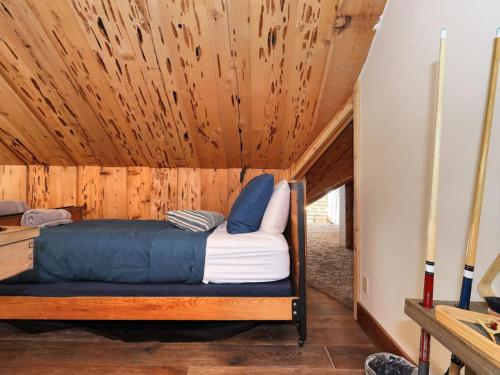 a bed in a room with a wooden ceiling at Mountain Haven Sundance Utah in Sundance