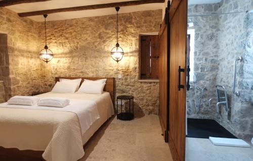 a bedroom with a bed and a glass shower at Casa do Cruzeiro in Ourém