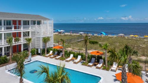 a view of the beach from the balcony of a resort at Oceaneer Hotel in Carolina Beach