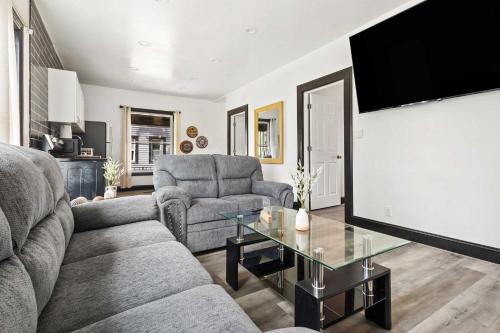 a living room with a couch and a table at Cozy 4BR Home in Heart of Niagara Falls in Niagara Falls