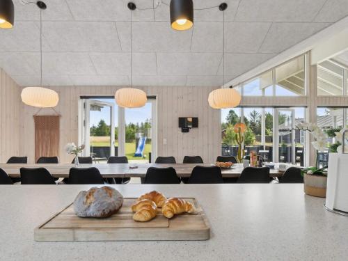 a table with a tray of bread on top of it at Luxury Retreat in albaek - By Traum Ferienwohnungen in Ålbæk
