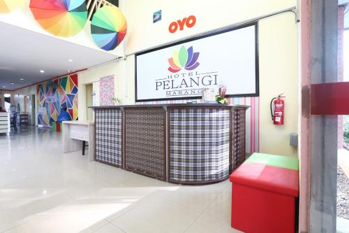 a restaurant with a bench and a sign on the wall at Hotel O Pelangi Marang in Marang