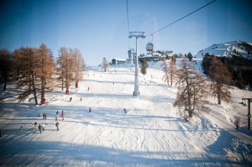 a group of people skiing down a snow covered slope at Hauts de Veysonnaz HV1 012 - SAUNA apartment 6 per in Veysonnaz