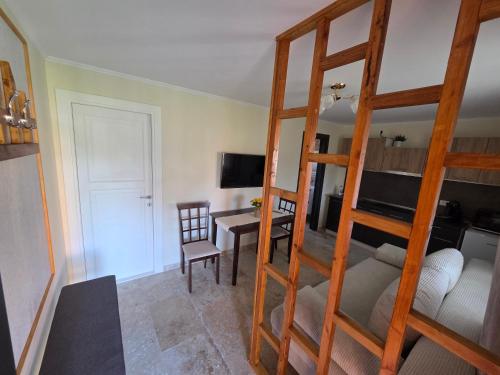 a bedroom with a bunk bed and a dining room at Căsuța fericită in Techirghiol