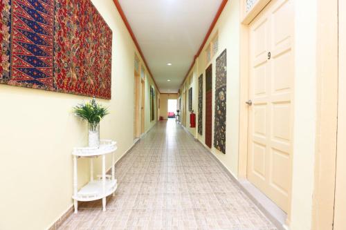 an empty hallway with a painting on the wall at Hotel O Pelangi Marang in Marang
