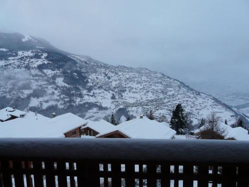 a snow covered mountain with a building in the foreground at Hortensia H 021 - VIEW studio 4 pers in Veysonnaz